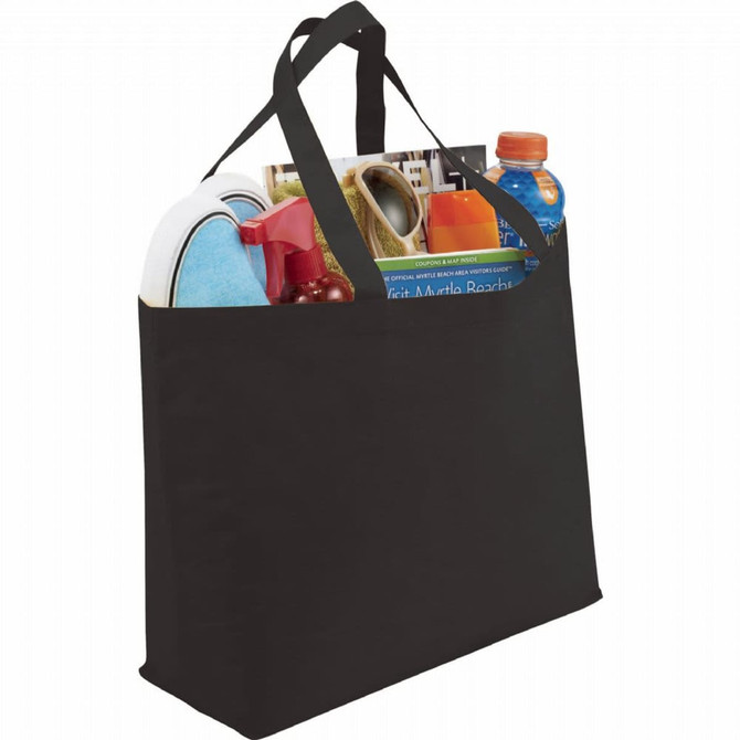 A black non-woven tote bag filled with a drink bottle, magazines, and various household items. The bag has two handles and a simple design.