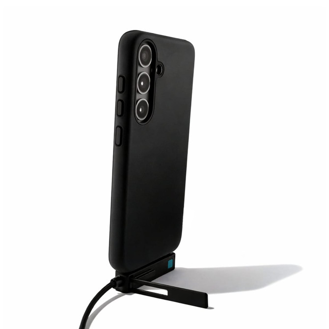 A black phone case with a stand and charging cable attached, featuring a camera cutout and buttons on the side.