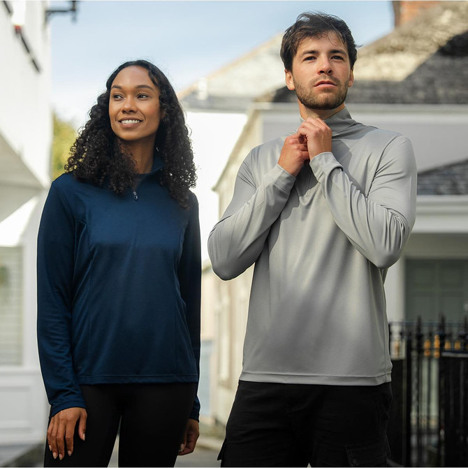 A navy blue women's pullover and a grey men's pullover with quarter zip, featuring logos.