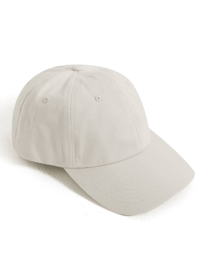 A cotton twill unstructured cap in a light beige colour, featuring a curved brim and a logo.