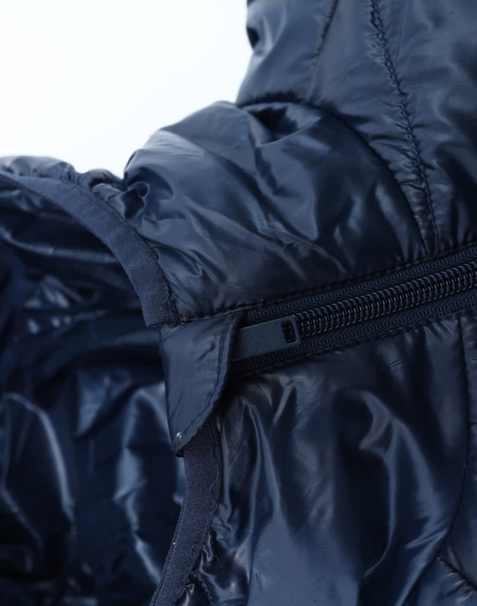 A lightweight hooded puffer jacket in navy blue, featuring a zip closure and shiny, insulated fabric.