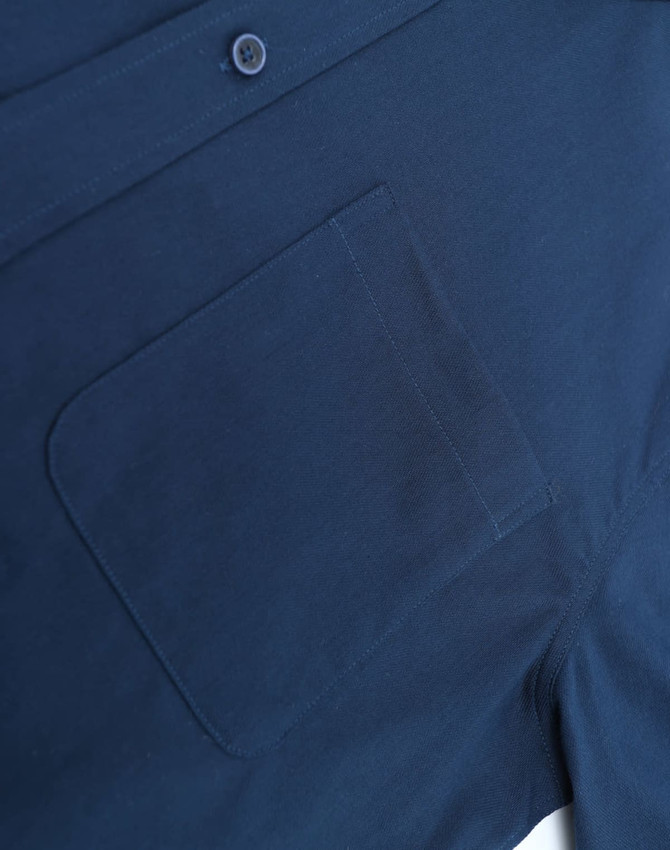 A navy blue men's smart casual cotton blend long-sleeve shirt featuring a chest pocket and a button.