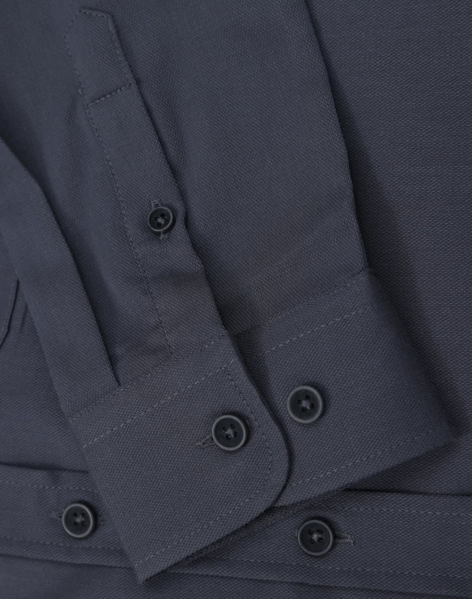 A dark grey ladies' long-sleeve shirt featuring buttoned cuffs and a smooth fabric texture. It has a logo present.