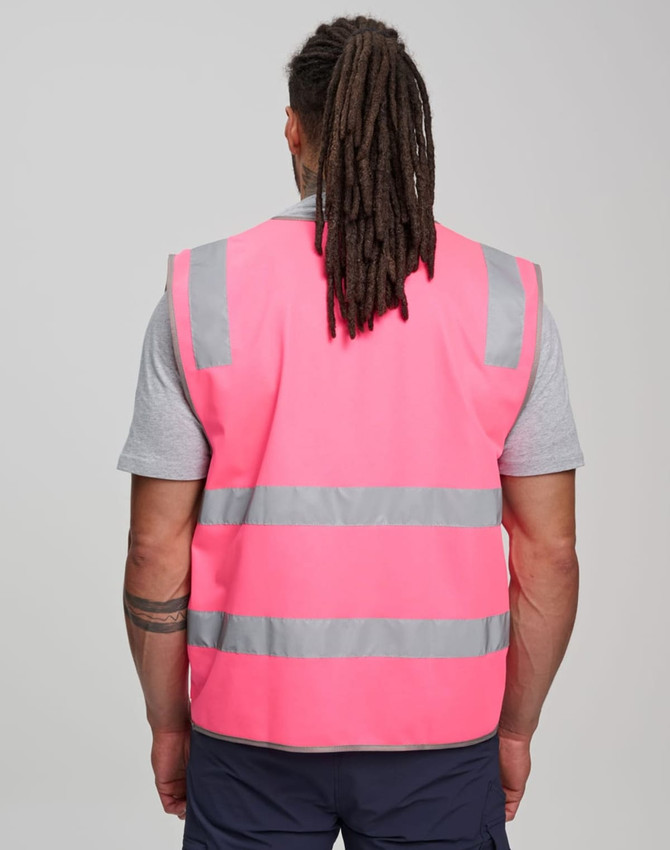 A pink high-visibility safety vest with reflective stripes, featuring ID and utility pockets. No visible branding.