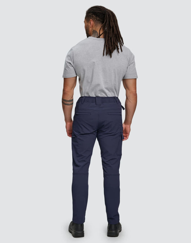Flexi work pants in navy, featuring a flexible fit and water-repellent fabric. The model is seen from the back.