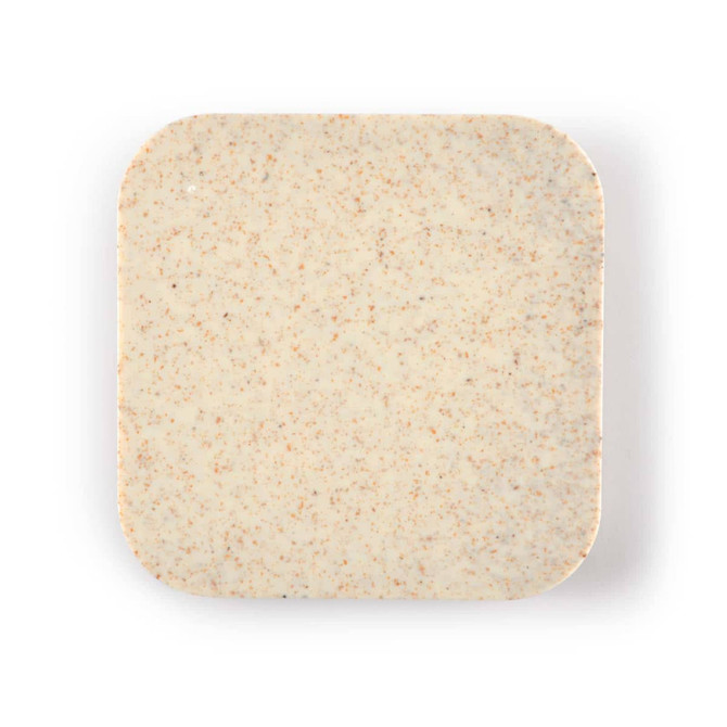 A wireless charger hub with a smooth, square surface featuring a light beige color with a subtle speckled texture.