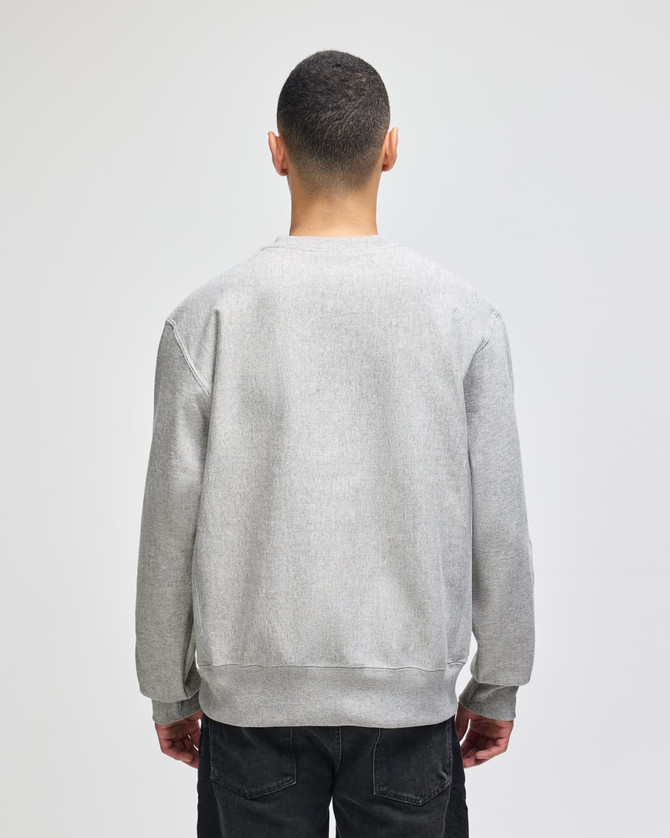 A grey Champion Reverse Weave® adult crew sweatshirt viewed from the back, featuring a simple design and a logo.