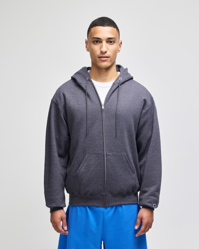 A grey hoodie with a front pocket and drawstring hood, worn over a white t-shirt and blue shorts.
