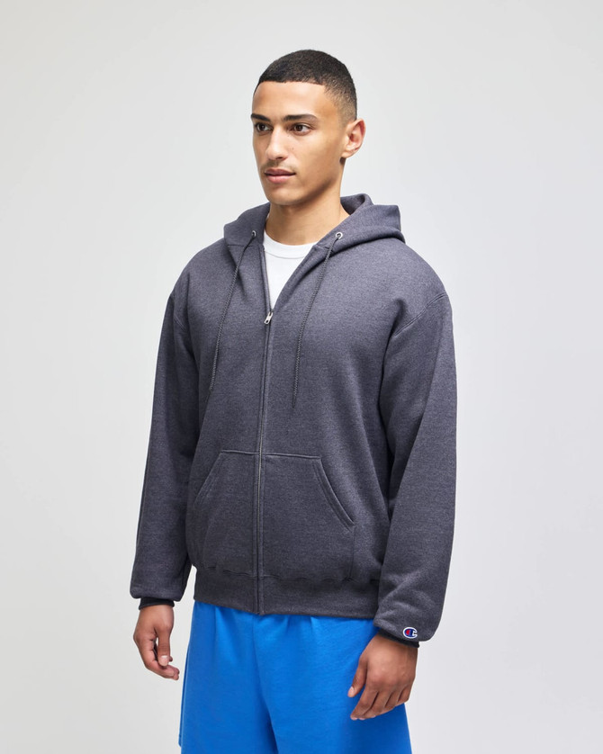A grey zip-up hoodie featuring a front pocket and a hood, worn by a model with blue shorts.