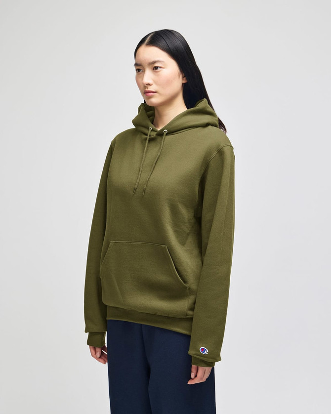 A green hooded sweatshirt with a front pocket and a logo on the sleeve, displayed on a model.