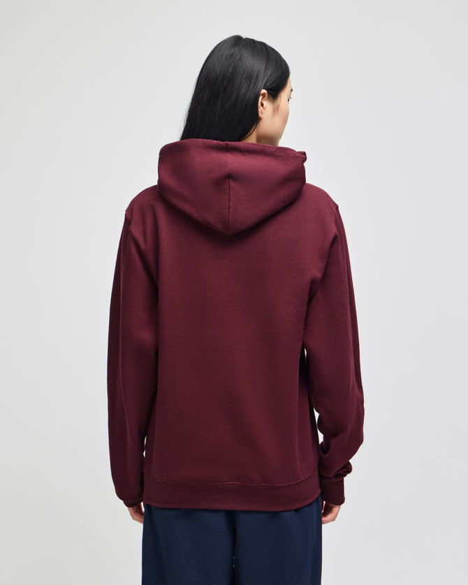 A burgundy hooded sweatshirt with a relaxed fit, featuring a hood and long sleeves, viewed from the back.