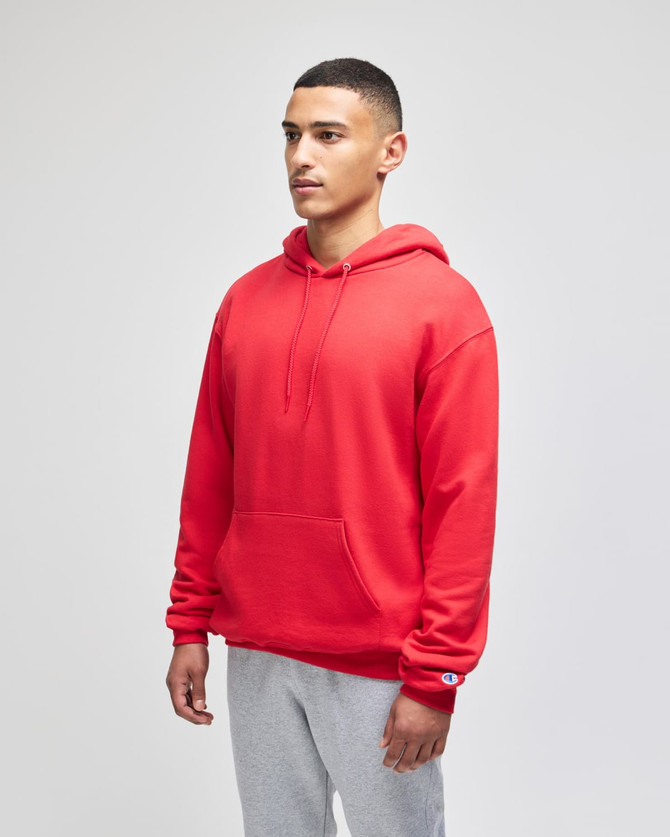 A red pullover hooded sweatshirt with a front pocket and a logo, worn by a model against a plain background.
