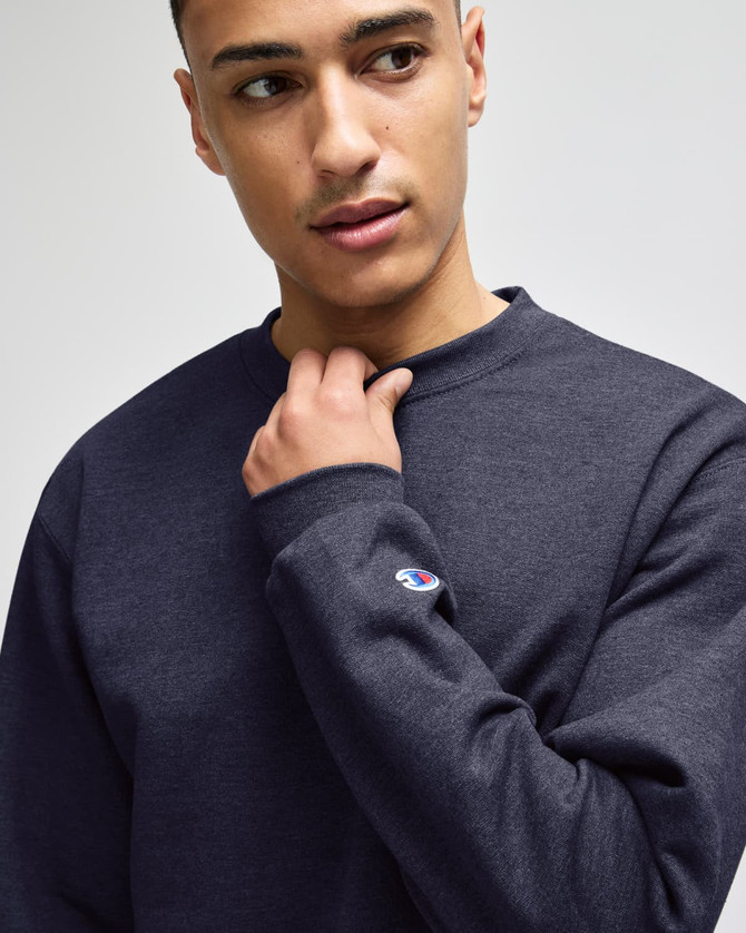 A navy long-sleeve t-shirt made from a soft fabric, featuring a small logo on the sleeve.