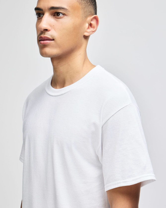 A white short-sleeve t-shirt displayed on a model, featuring a simple design and branding.