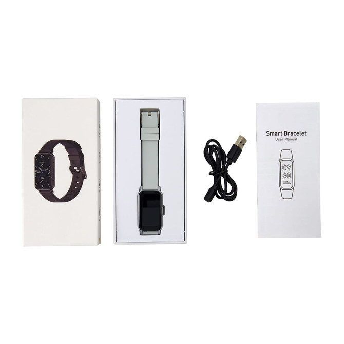 A slim smart watch in a box, featuring a grey strap, charging cable, user manual, and packaging with a dark watch design.