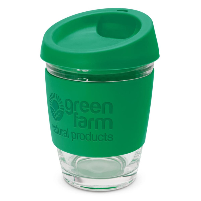 A drink cup featuring a clear glass body and a green silicone lid and sleeve, including a logo.