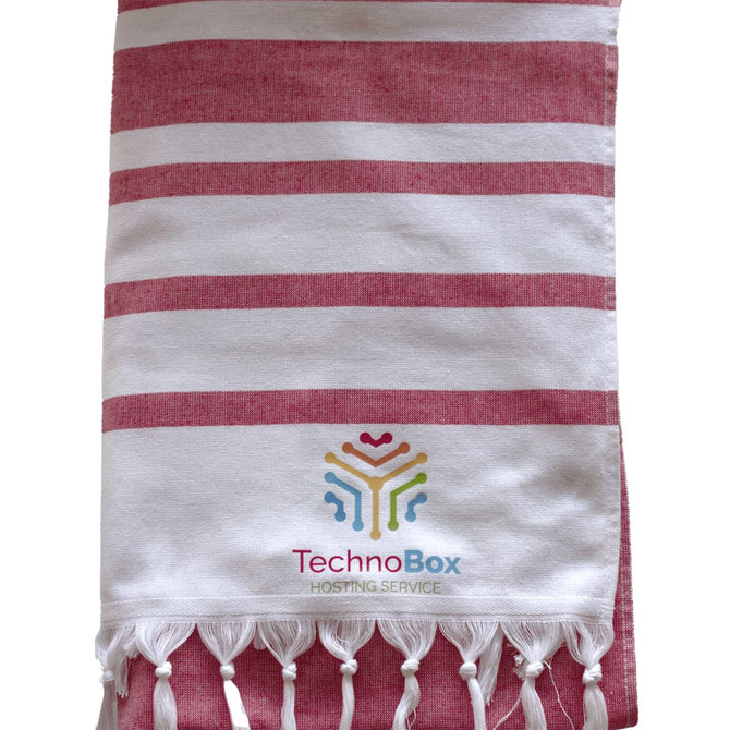 A striped Turkish beach towel in red and white, featuring tassels and a logo at the bottom.