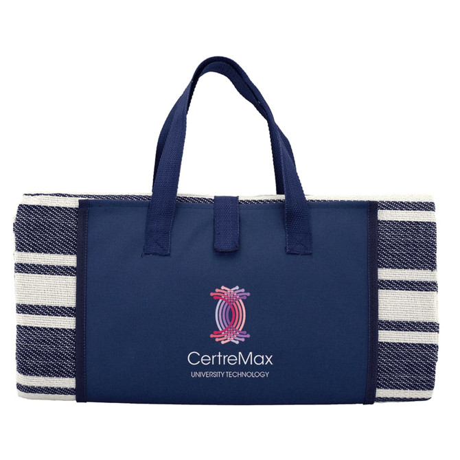A navy picnic rug with a striped design, featuring sturdy handles and a logo on the front.