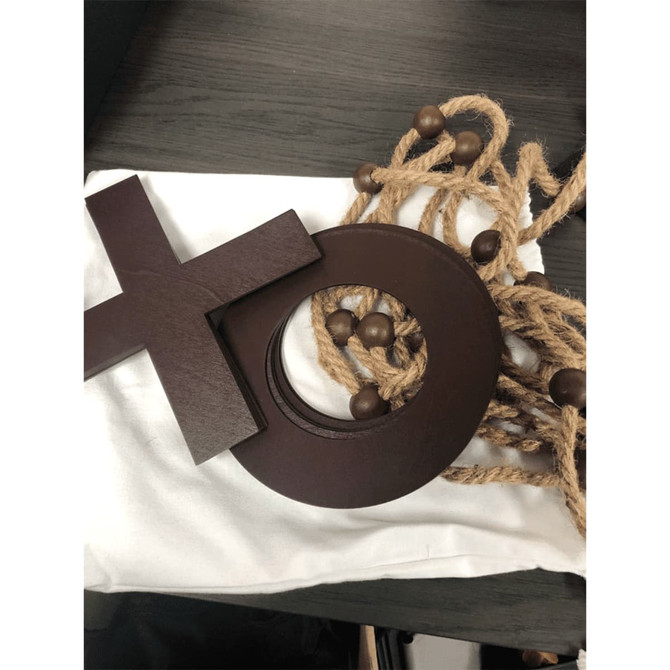 A wooden Trekk Tic Tac Toe game with brown pieces and a canvas bag, featuring a rope for storage.