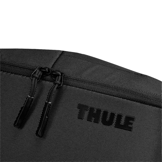 A black toiletry bag with a textured surface, featuring a zip closure and a logo.