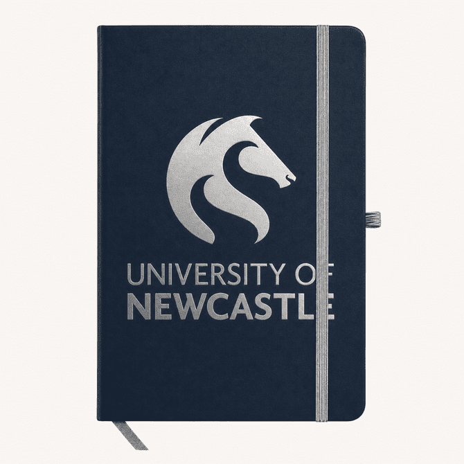 A navy A5 notebook with a branded logo on the cover and an elastic band closure.