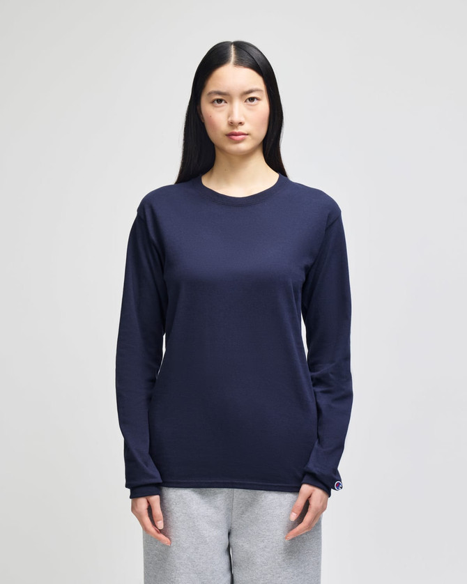 A long-sleeve t-shirt in navy blue, featuring a logo, worn by a model with straight black hair.