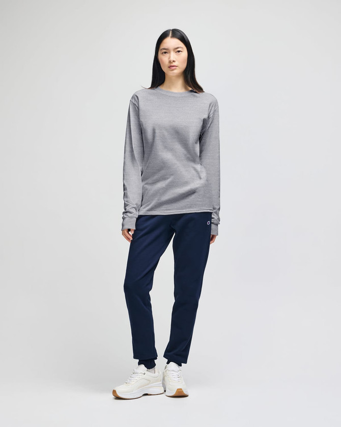 A long-sleeve grey T-shirt paired with navy pants, featuring a logo on the shirt.