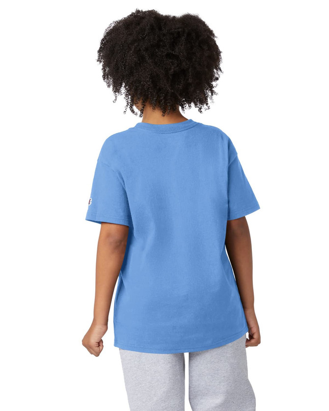 A blue short sleeve T-shirt with a relaxed fit, featuring a logo. The model has curly hair and is wearing grey pants.