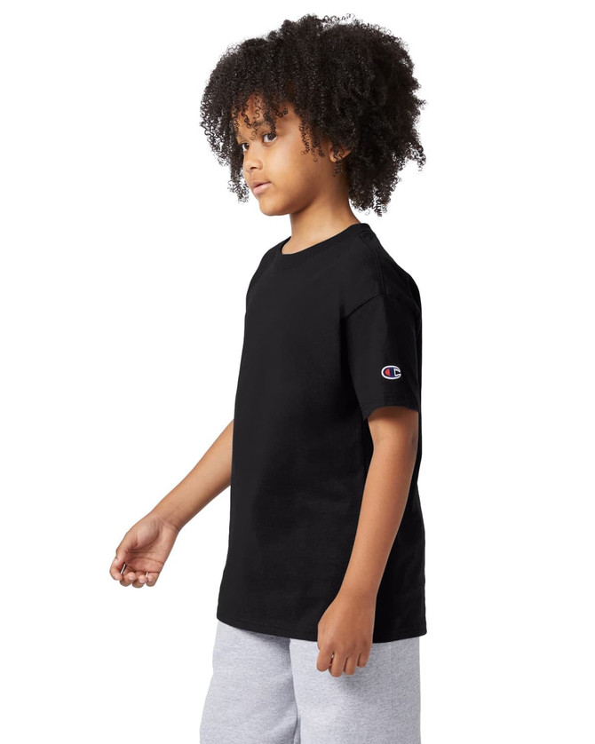 A black Champion youth jersey short sleeve t-shirt displayed on a model with curly hair, wearing grey shorts.
