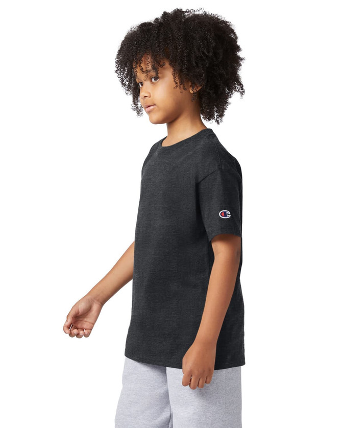 A short sleeve t-shirt in black with a logo on the sleeve, modelled by a child.
