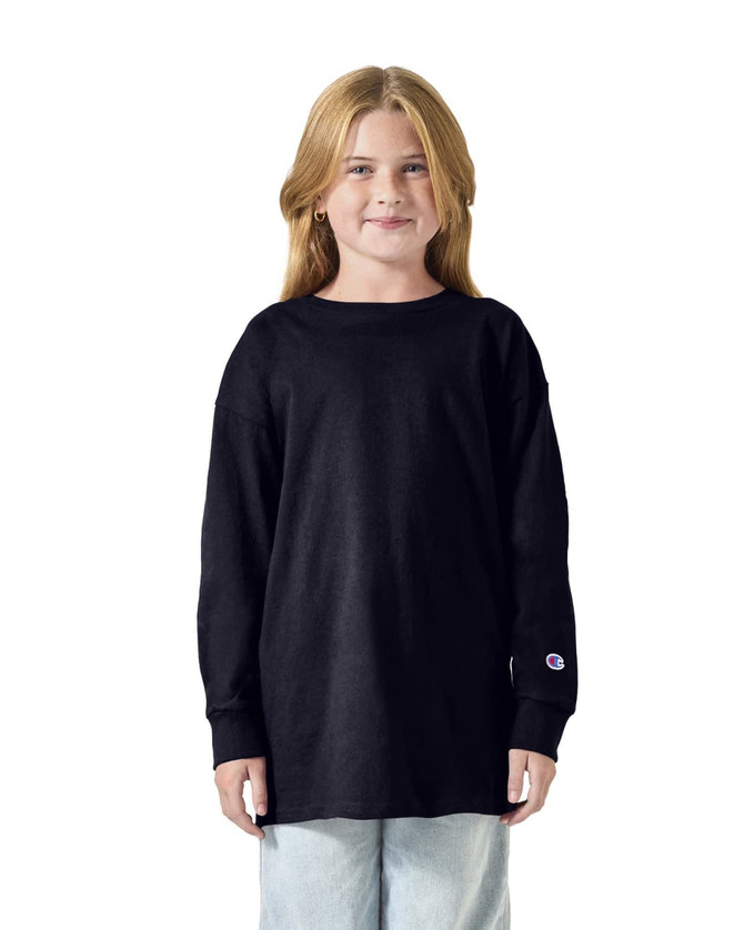 A youth long sleeve T-shirt in black, featuring a logo on the sleeve, worn by a child.