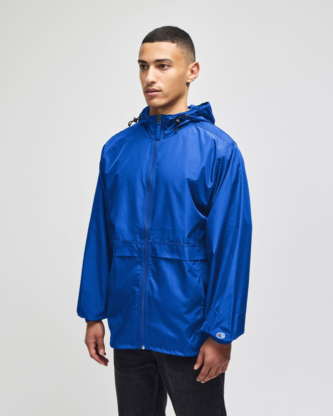 A full-zip anorak jacket in vibrant blue, featuring a hood and logo, worn by a model standing.