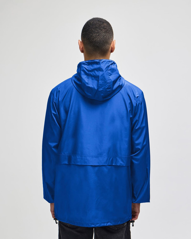 A blue Champion Adult Full-Zip Anorak Jacket viewed from the back, featuring a hood and a logo.