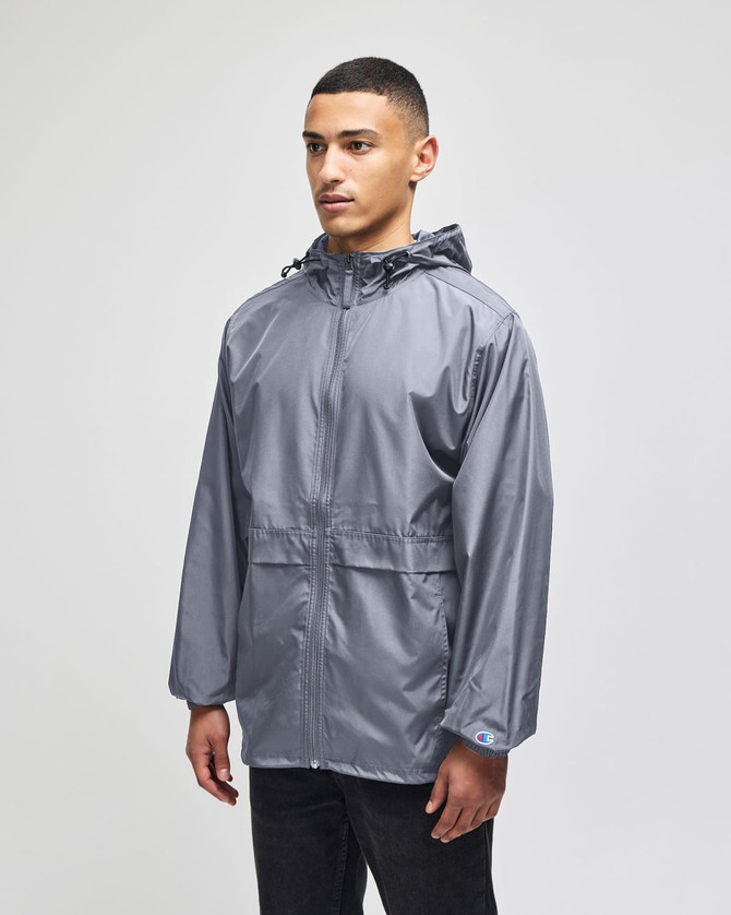 A grey full-zip anorak jacket with a hood and a logo, designed for adults, featuring a relaxed fit.