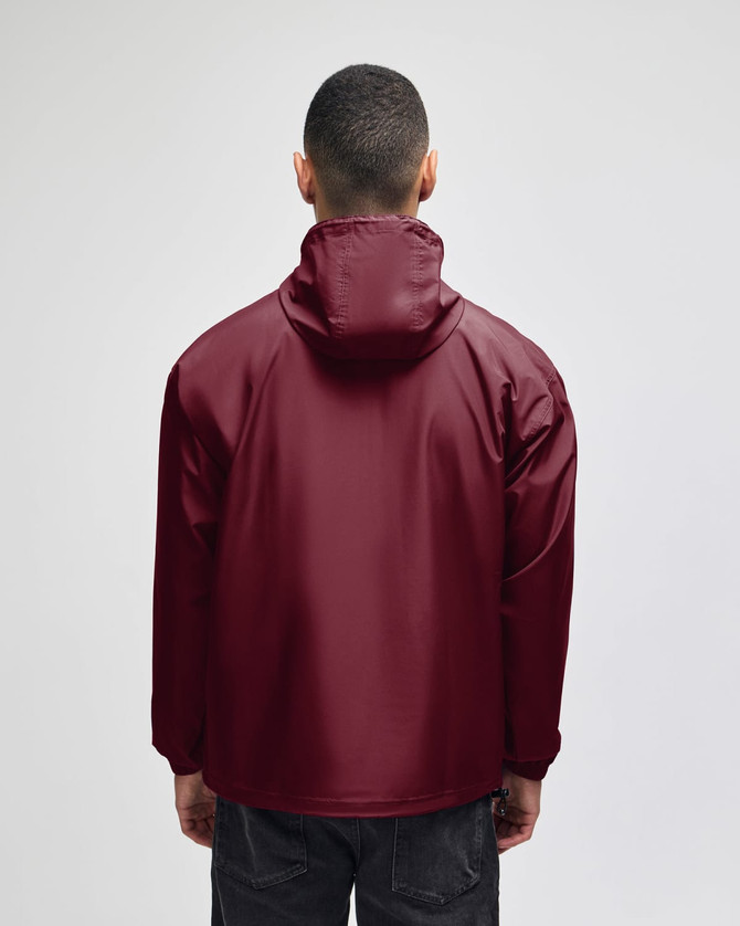 A maroon packable anorak jacket with a hood, viewed from the back, featuring a logo.