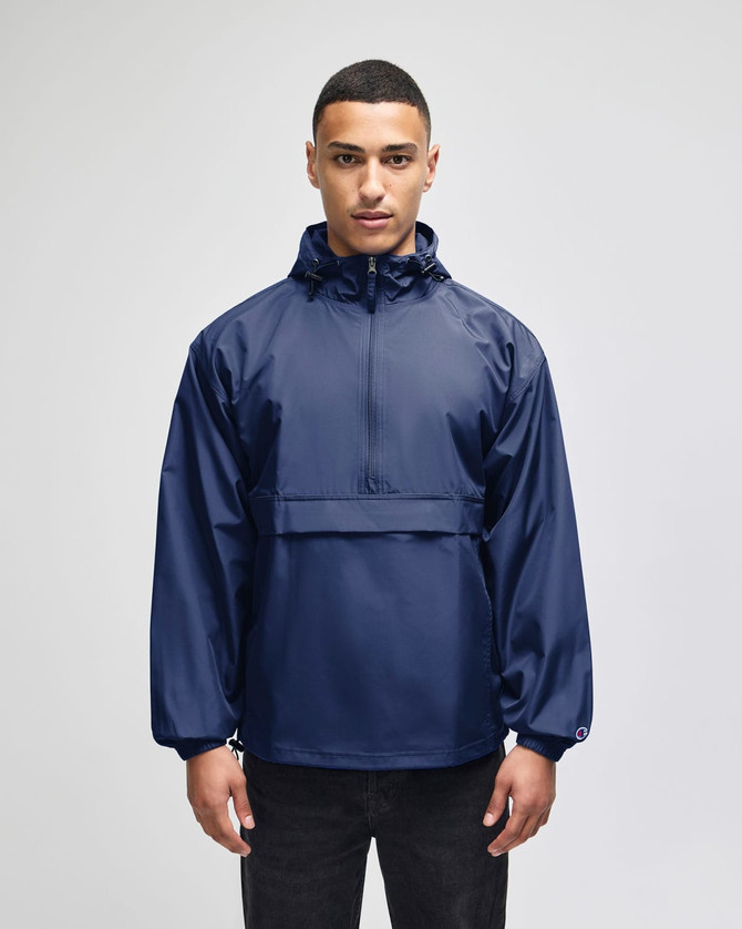 A navy packable anorak jacket with a hood and front pocket, featuring a logo on the chest.