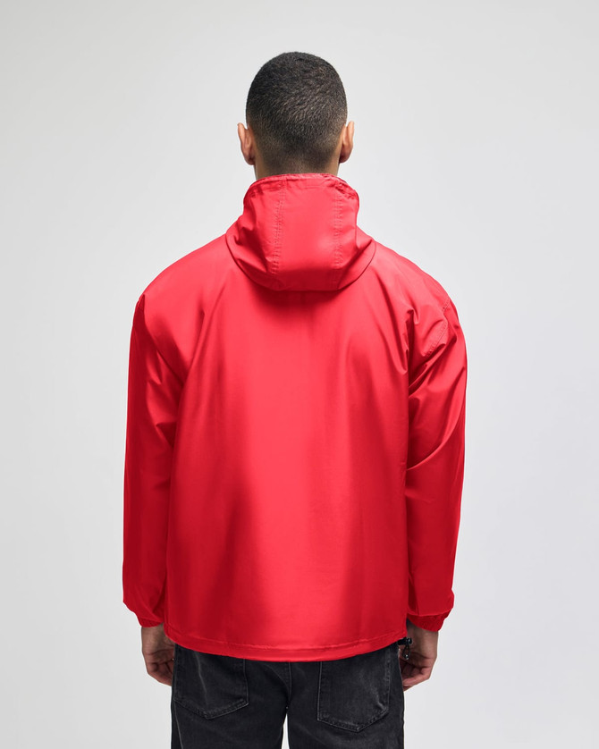 A red packable anorak jacket with a hood, viewed from the back. It features a simple design and has a logo.