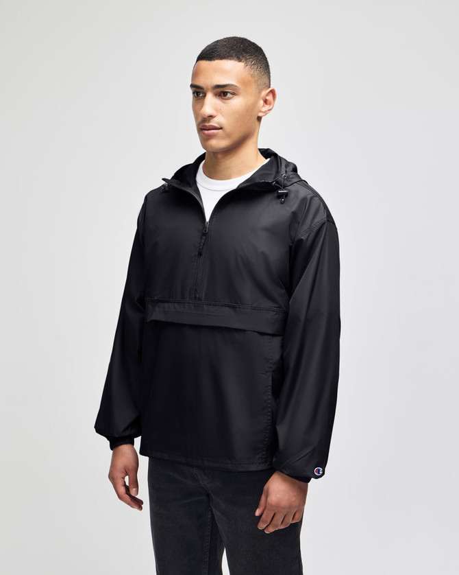 A black packable anorak jacket with a hood, featuring an adjustable drawstring and front pocket, worn by a male model.