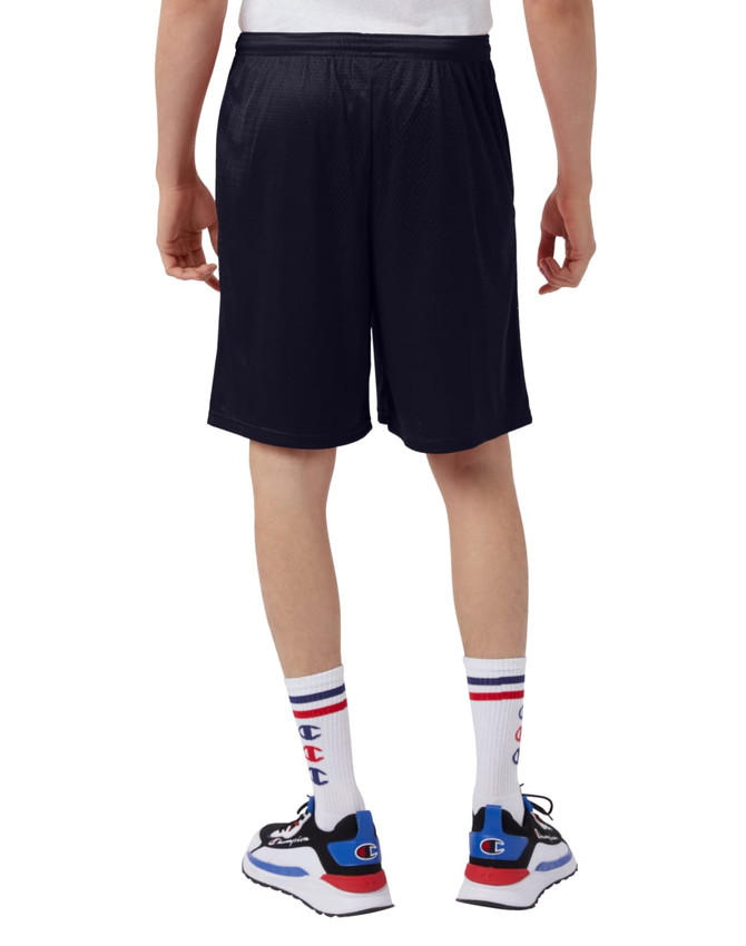 A person wearing navy Champion adult mesh shorts with pockets, viewed from the back, paired with stylish shoes and socks.
