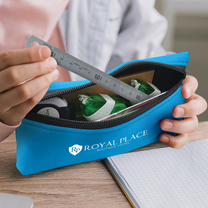 A blue pencil case with a zipper, containing a ruler and green highlighters, held by a person. Features a logo.
