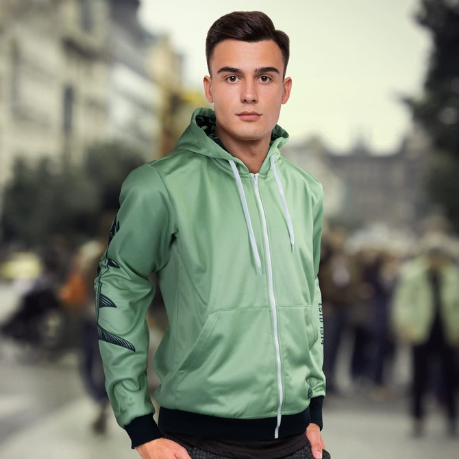 A mint green custom men's sports zipped hoodie featuring a logo and hood. The model is outdoors with a blurred background.