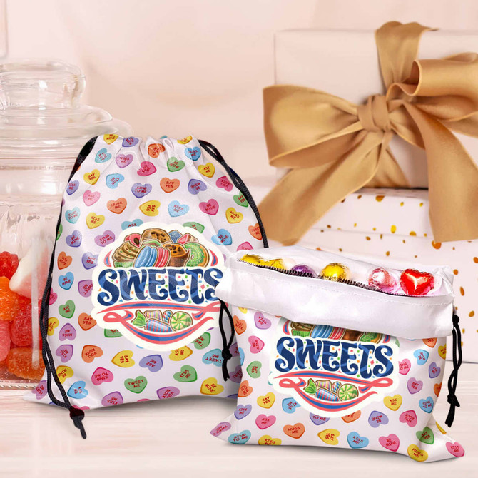A medium satin gift bag in white with colourful sweet-themed patterns and a drawstring closure. It has a logo.
