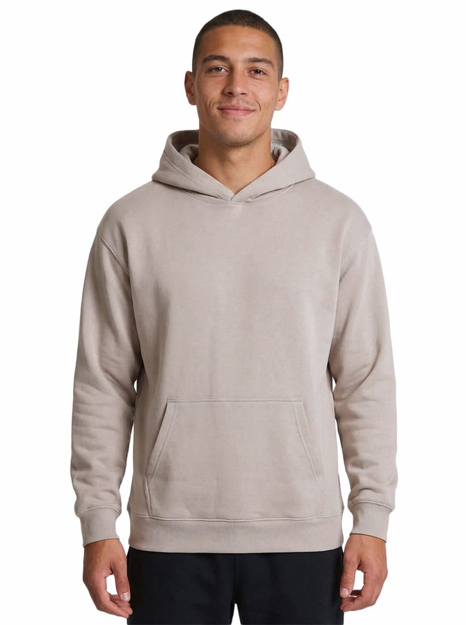 A light beige hoodie with a kangaroo pocket and hood, displayed on a smiling model. The product features a logo.