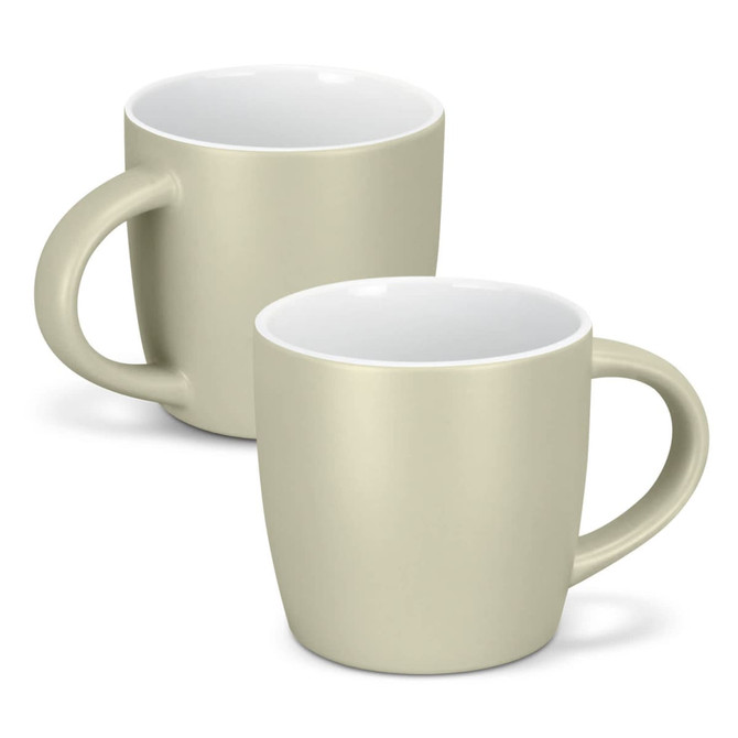 A mocha coffee mug in a soft beige colour with a white interior and a curved handle. Two mugs are displayed.