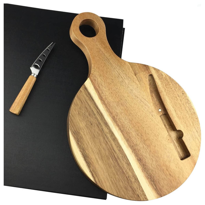 A round wooden cheeseboard with a handle, accompanied by a cheese knife with a wooden handle, on a black backdrop.