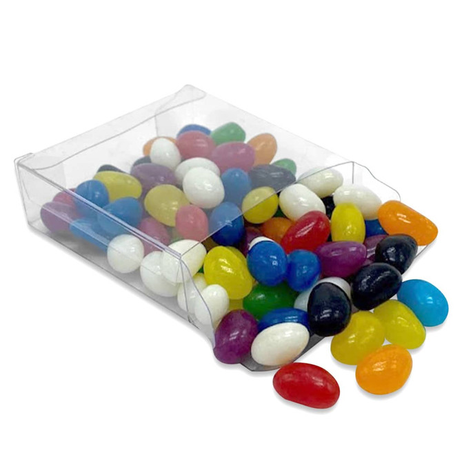 A clear box containing a mix of colourful jelly beans in various shapes and sizes, some spilling out.