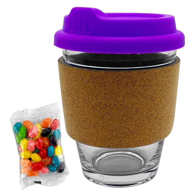 A glass coffee cup with a cork band and purple lid, accompanied by a packet of colourful jelly beans.