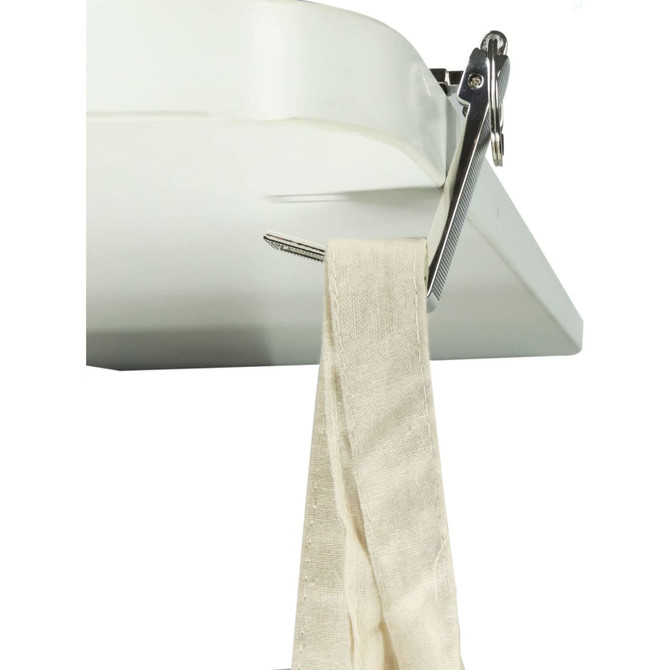 A mobile stand and hanger key ring in silver, attached to a white surface, holding a beige fabric strap.