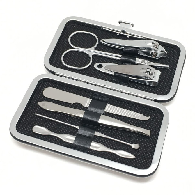 A silver manicure set contains scissors, nail clippers, tweezers, and other grooming tools in a compact case.