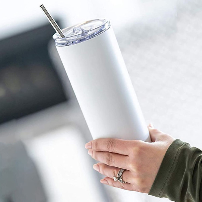 A white drink bottle with a clear lid and metal straw, held in a hand, featuring a sleek design.